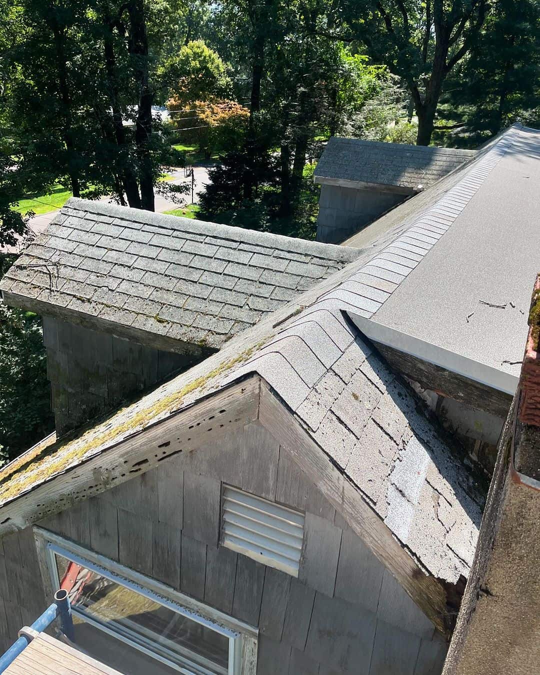 Roofing underlayment and shingles around intersecting roof slopes