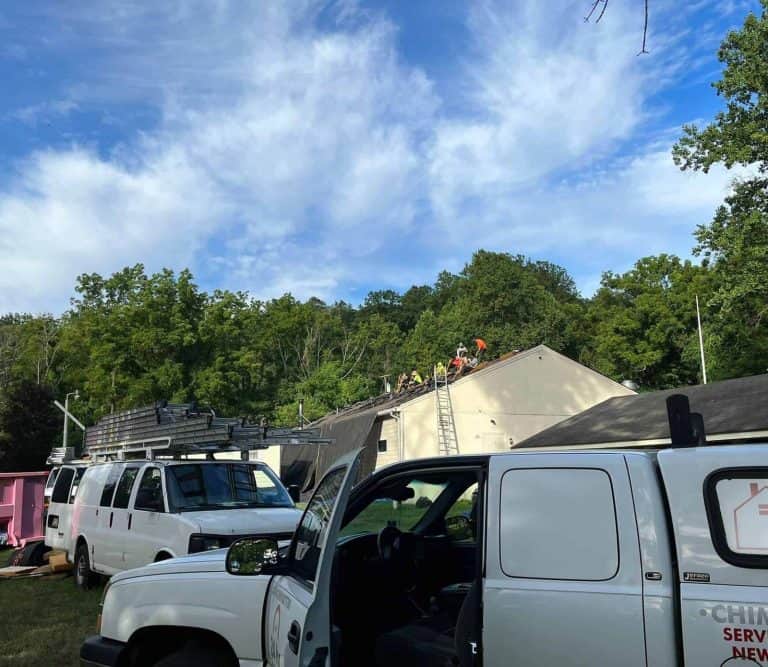 Boundless work trucks and dumpster at a New Jersey job site